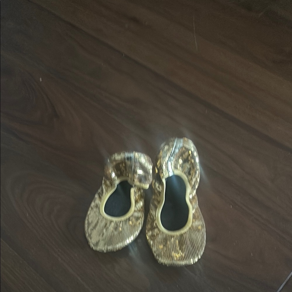 Gold sequence woman’s foldable flats.